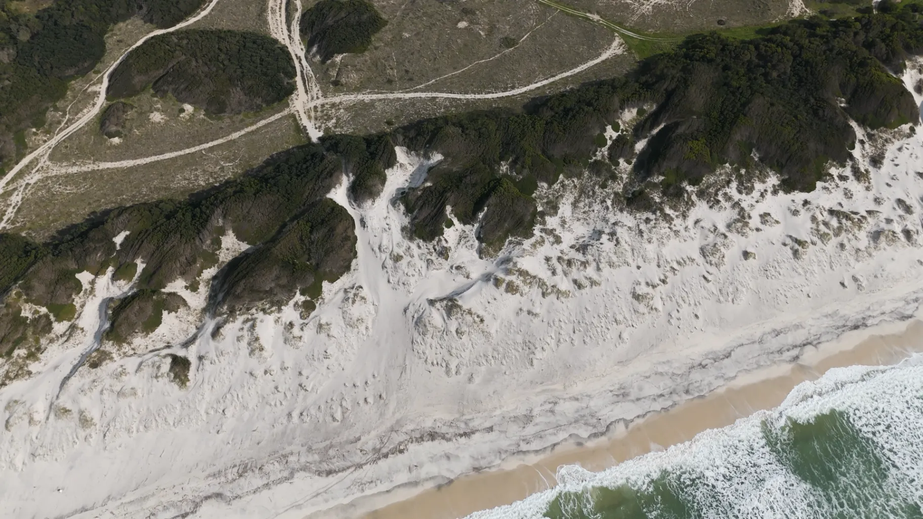 Horseback rider crossing Atlantic dunes along Portugal's western coast