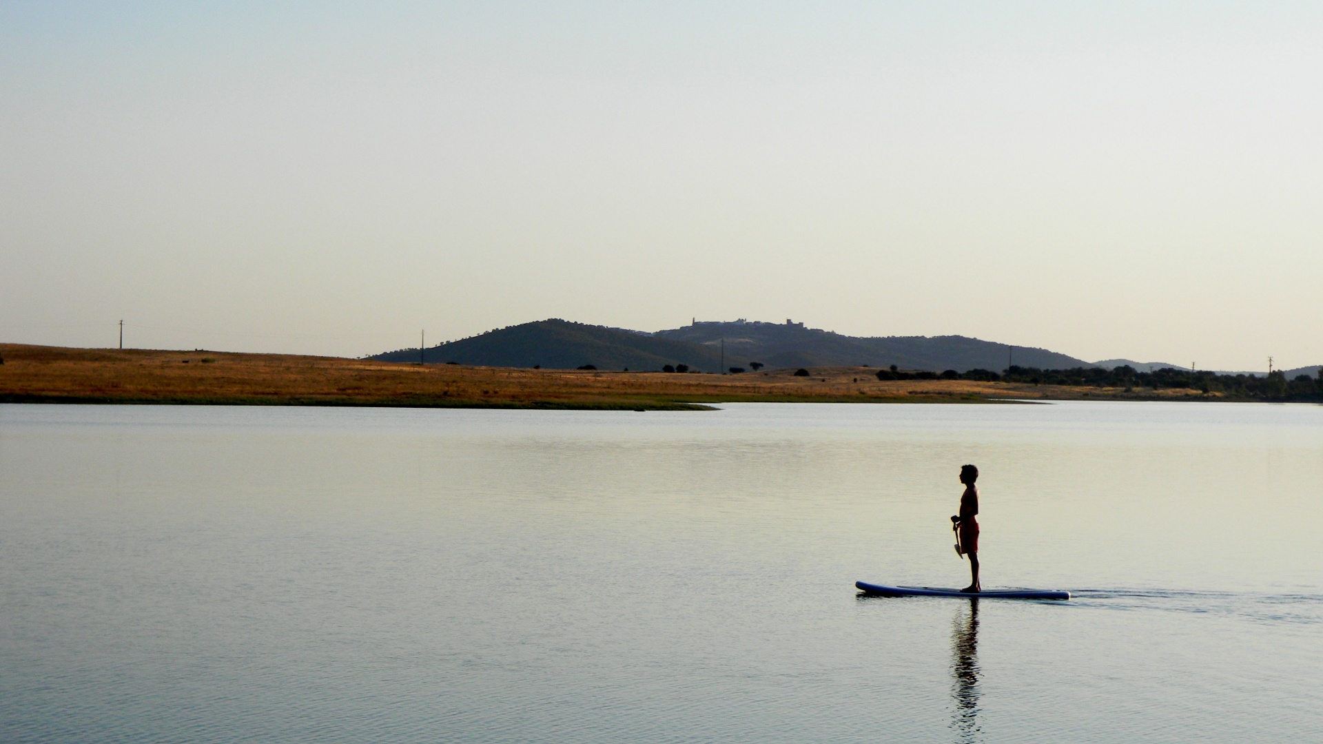 Stand-up paddle boarding on the calm waters of a Portuguese lagoon