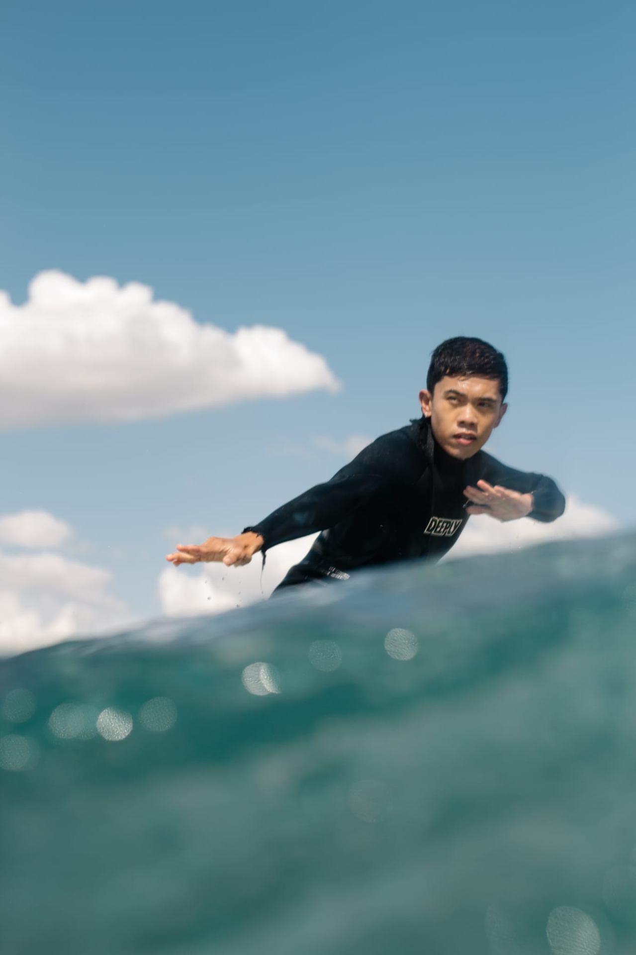 Surfer riding a wave at a quiet beach break on the Portuguese coastline
